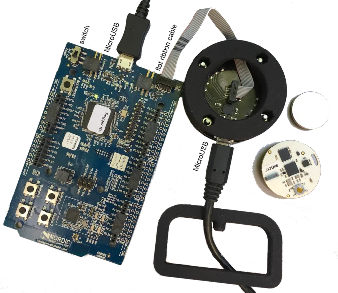 The OpenBeacon Programmer wired to the Nordic nRF51-DK board with a flat ribbon cable, both connected by USB